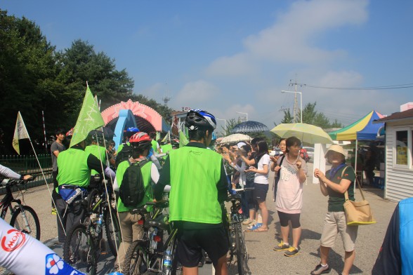 부천 여성사역, DMZ 통일촌교회 방문 전 자전거투어하는 성도들에게 손 흔드는 모습.